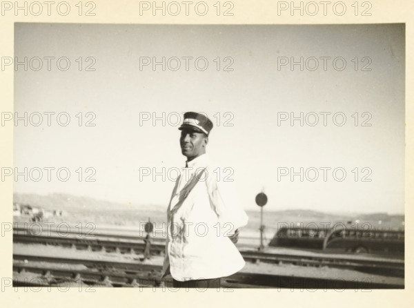 Portrait of an American man, probably working on a train, Unknown location in the United States: