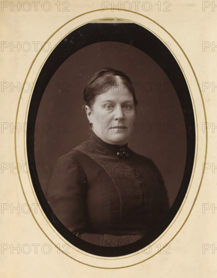 Portrait of a woman, album page, photograph, cabinet photograph, This photo is part of an album.,