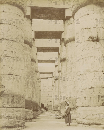 Temple of Karnak, Thebes (Luxor), Man in a colonnade with hieroglyphs (former title), photograph,