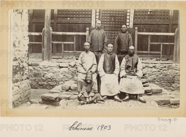 Chinese men and a boy in front of a house in Tibet, photograph, Part of Photo album with 24 photos