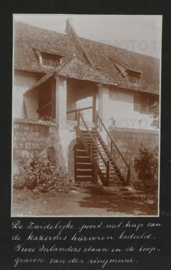 The southern gate with stairs of the barracks mentioned above. Two natives are standing in the