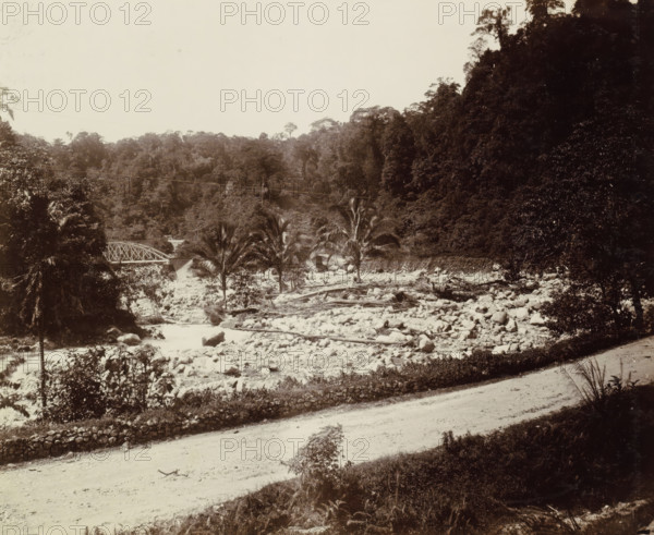 Dried-up riverbed with railway bridge over a brook in the Dutch East Indies, album page,