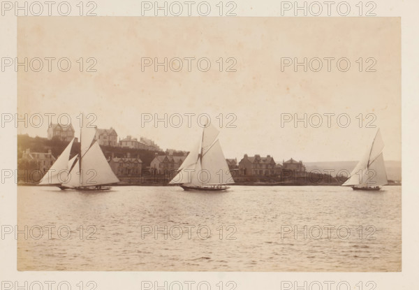 Sailing ships Yvonne, Doris and Darthula in the water with buildings in the background, album page,