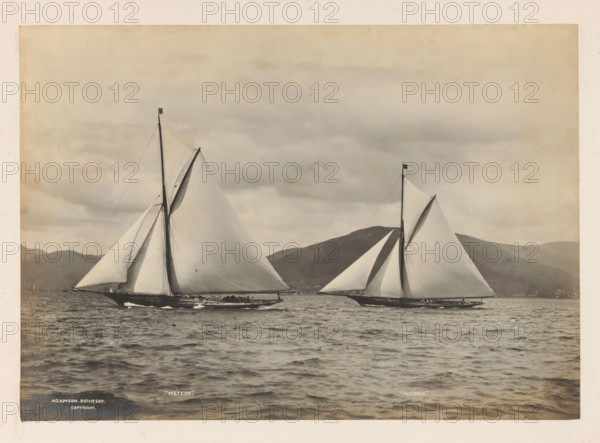 Sailing ships Meteor and Iverna at sea with a hilly landscape in the background, album page,