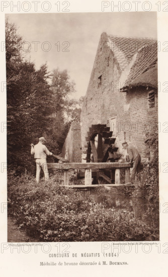 Two men adjust the water level at a watermill, in Eijsden, page, photomechanical print,