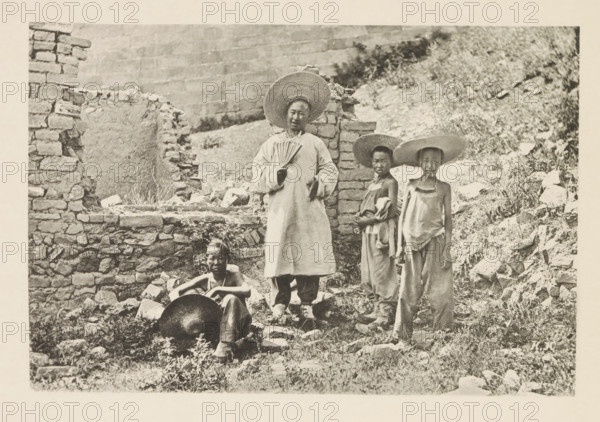 Tour guide Barthélemy and three mule drivers in front of a ruin in China, Barthélemy et les trois