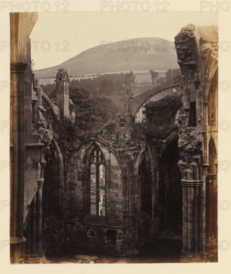View of a chapel of the ruins of Melrose Abbey with Eildon Hill in the background, photograph,