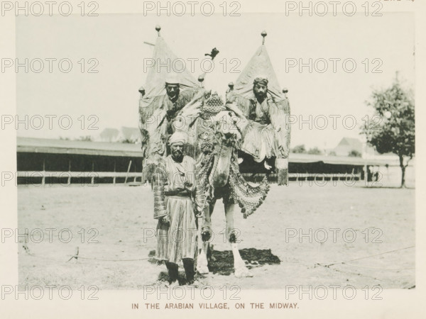In the Arabian village, on the Midway, Three men with a camel at the World's Columbian Exposition
