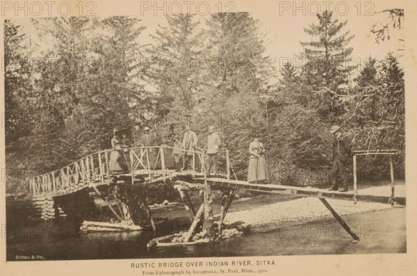 Group portrait of a group on a bridge in Sitka, Rustic bridge over Indian river, Sitka, page,