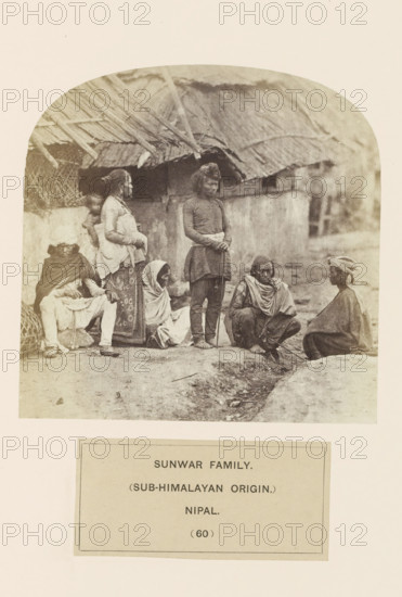 An unknown family on the street in front of houses from the Sunuwar tribe of Nepal, photograph,