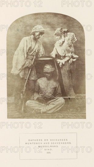 Portrait of three unknown hunters from Sindh, Pakistan, with a dead bird and rifles, photograph,