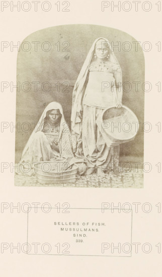 Portrait of two unknown fish sellers in Sindh, Pakistan, photograph, page, inscription: 'SELLERS OF