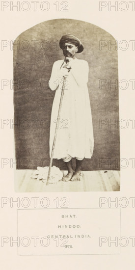 Portrait of an unknown man from the Bhat community with a rod, Madhya Pradesh, India, photograph,