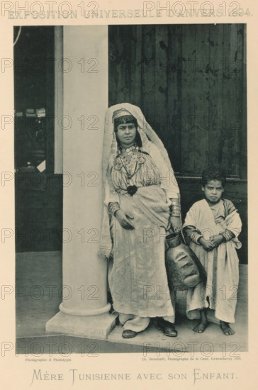 Mother and son in front of a building in the Tunisian part of the Antwerp World Exhibition in 1894,