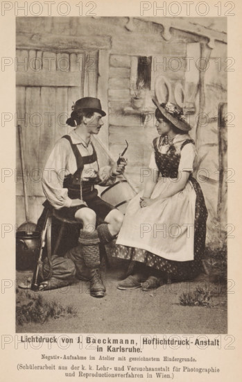 Man and woman in traditional clothing sitting in a photo studio, page, photomechanical print,