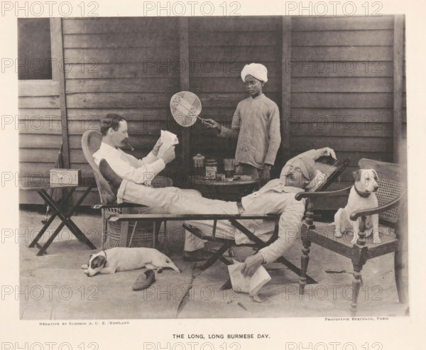 Two seated men and a boy with a fan behind them, The long, long Burmese day, page, photomechanical