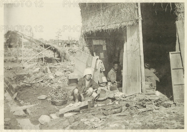 Temporary house in a village in Japan destroyed by an earthquake, page, photomechanical print,