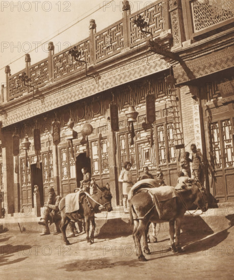 Unknown persons and two donkeys in front of a shop in Beijing, page, photomechanical print,