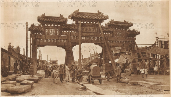 Street view with paifang, page, photomechanical print, photographer: Donald Mennie, Beijing, cliché