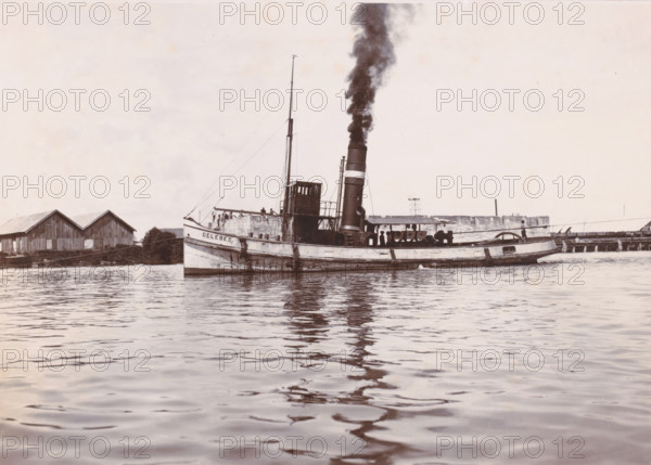 Tugboat 'Celebes', Ocean Harbor Belawan, photograph, The tugboat 'Celebes' with smoking chimney.
