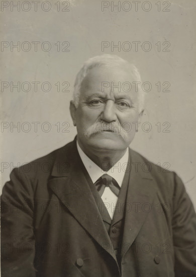 Portrait of an older man with a mustache, in dark clothing, photograph, in dark clothing.,