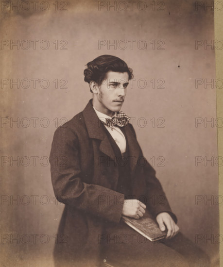 Portrait of an unknown seated young man with a checkered bow tie, with a book in his hand,