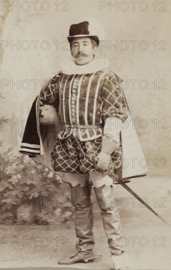 Portrait of a young man in costume with sword, identified as W. Birnie, album page, photograph,