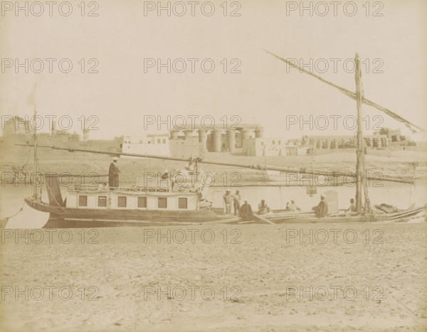 Sailboat (dahabie) on the Nile with the Great Colonnade in Luxor in the background, photograph,