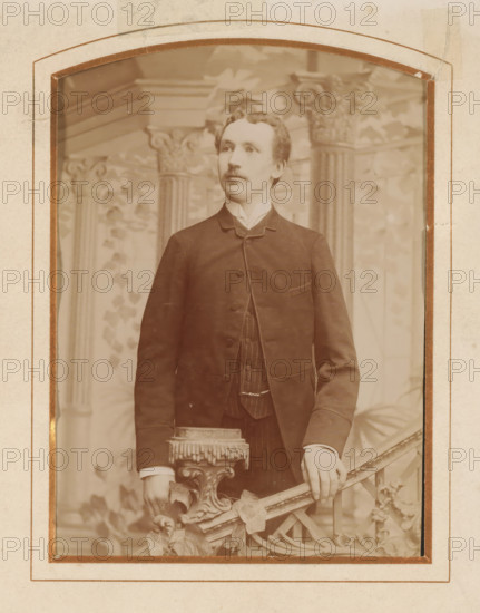 Portrait of a young man, standing by a stair railing, album page, photograph, cabinet photograph,
