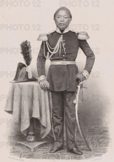 Portrait of Youda Negara, Prince of Djoejocarta, print, The sitter stands next to a table with a