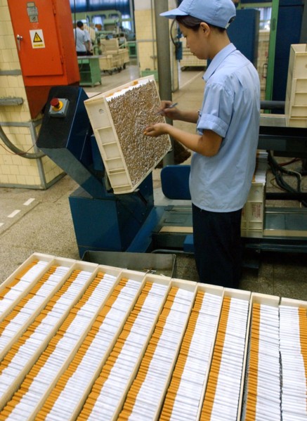 A worker makes cigarette in the workshop of Zhengzhou Tobacco Factory in Henan, China