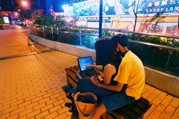 A couple sit on the street chair in Shanghai,China
