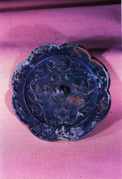 A bronze mirror with design of dragon, phoenix and sunflower dated from Tang Dynasty,China
