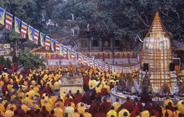 Onks and nuns pray beneath the sacred Bo Tree at Bodhgaya India