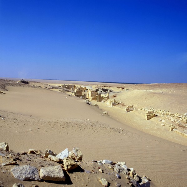 The site of Medinet Madi buried beneath the sands: processional avenue lined with lions at the entrance to the temple