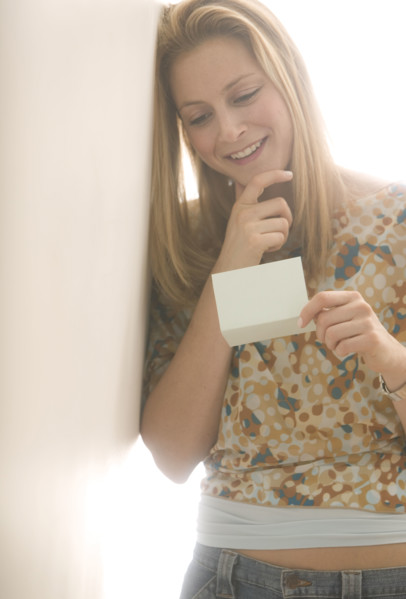 Young female reading a note.