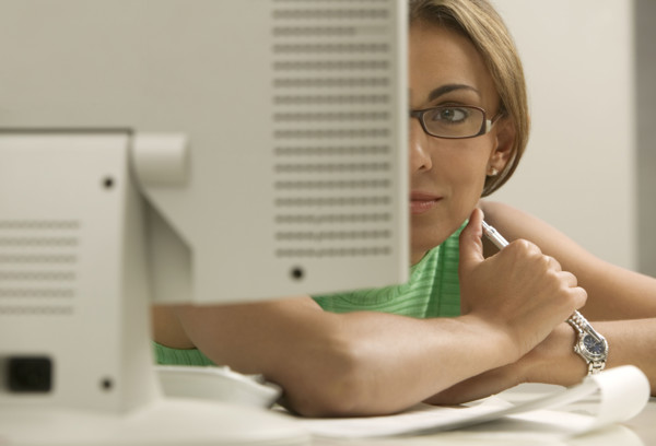Woman looking at computer monitor.