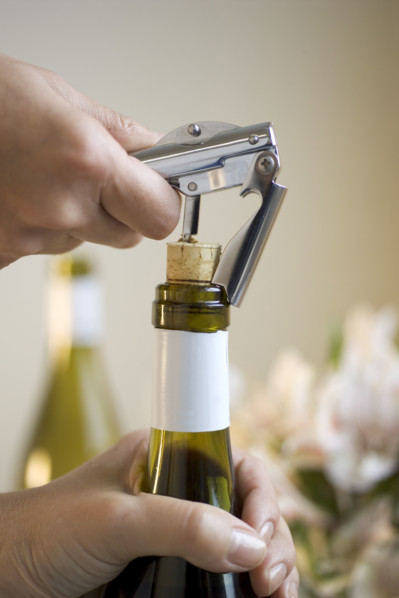 Opening a bottle of wine.