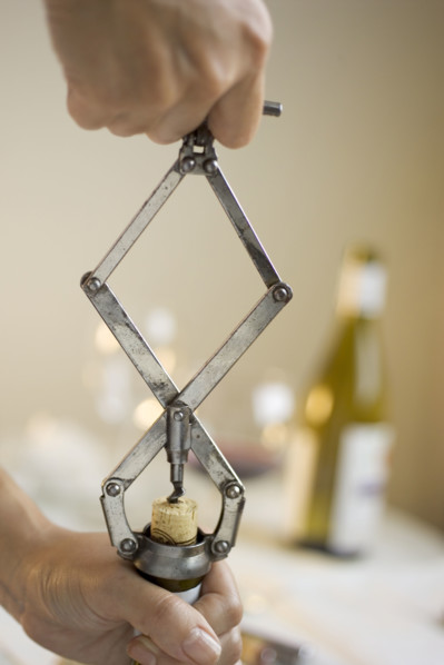 Opening a bottle of wine.