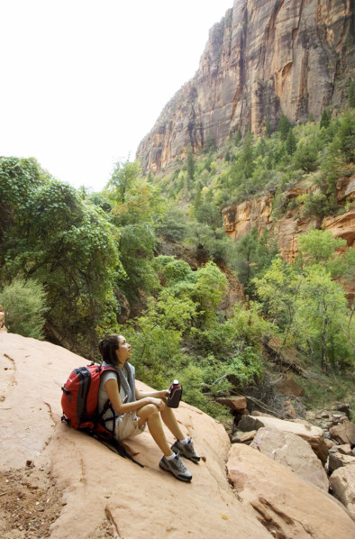 Female hiker resting on a rock.