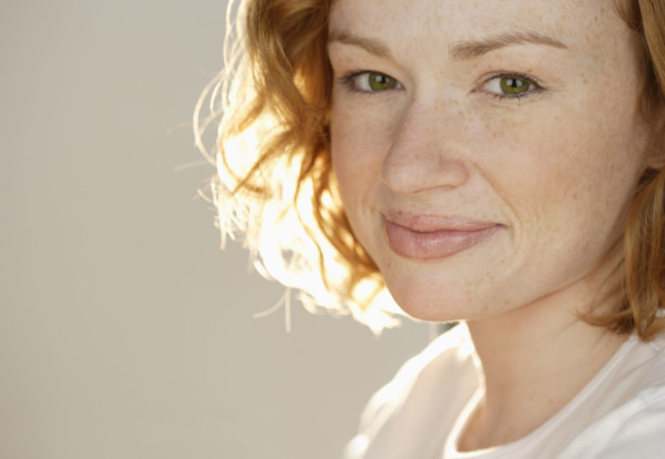 Portrait of smiling redheaded woman.