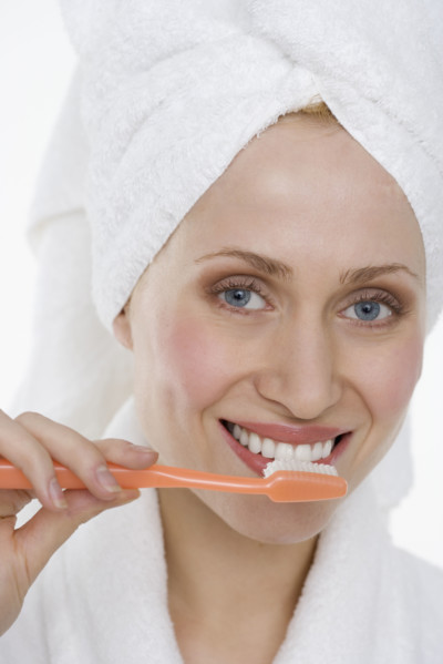 Woman brushing teeth.
