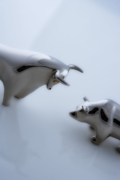 Bull and bear figurines facing-off.