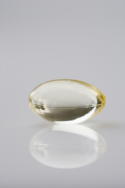 One gelcap and its reflection.