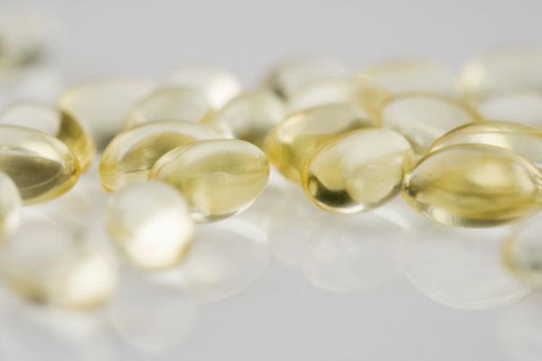 Closeup of several yellow gelcaps.