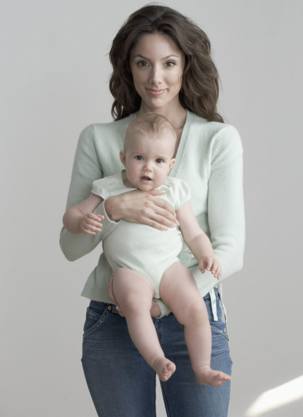 Standing woman holding baby.