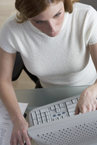 Woman working on computer at desk.