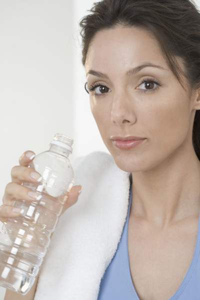 Woman with towel and water bottle.