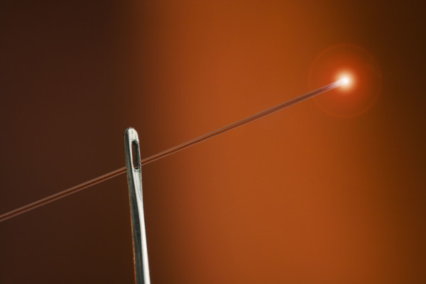 Glowing fiber optic thread with needle.