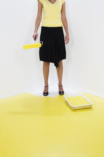 Woman painting herself into a corner.